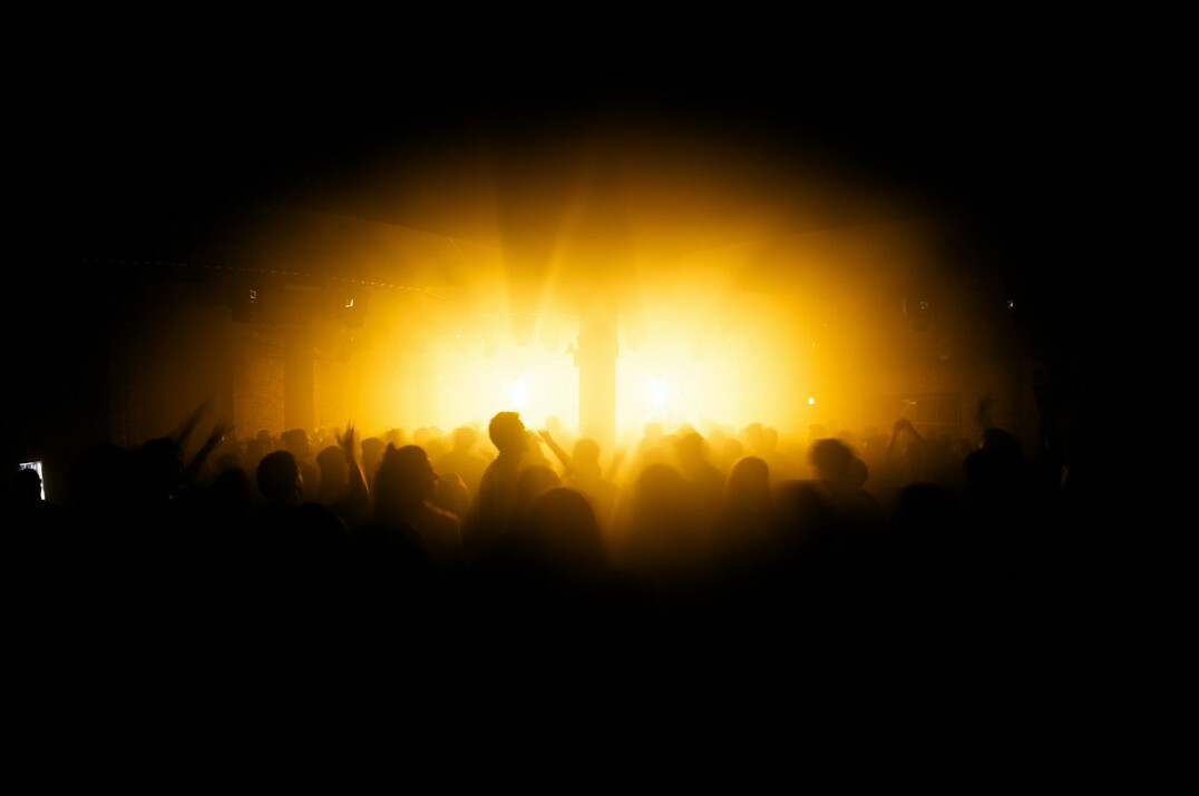 Concert with a glowing stage and audience silhouettes