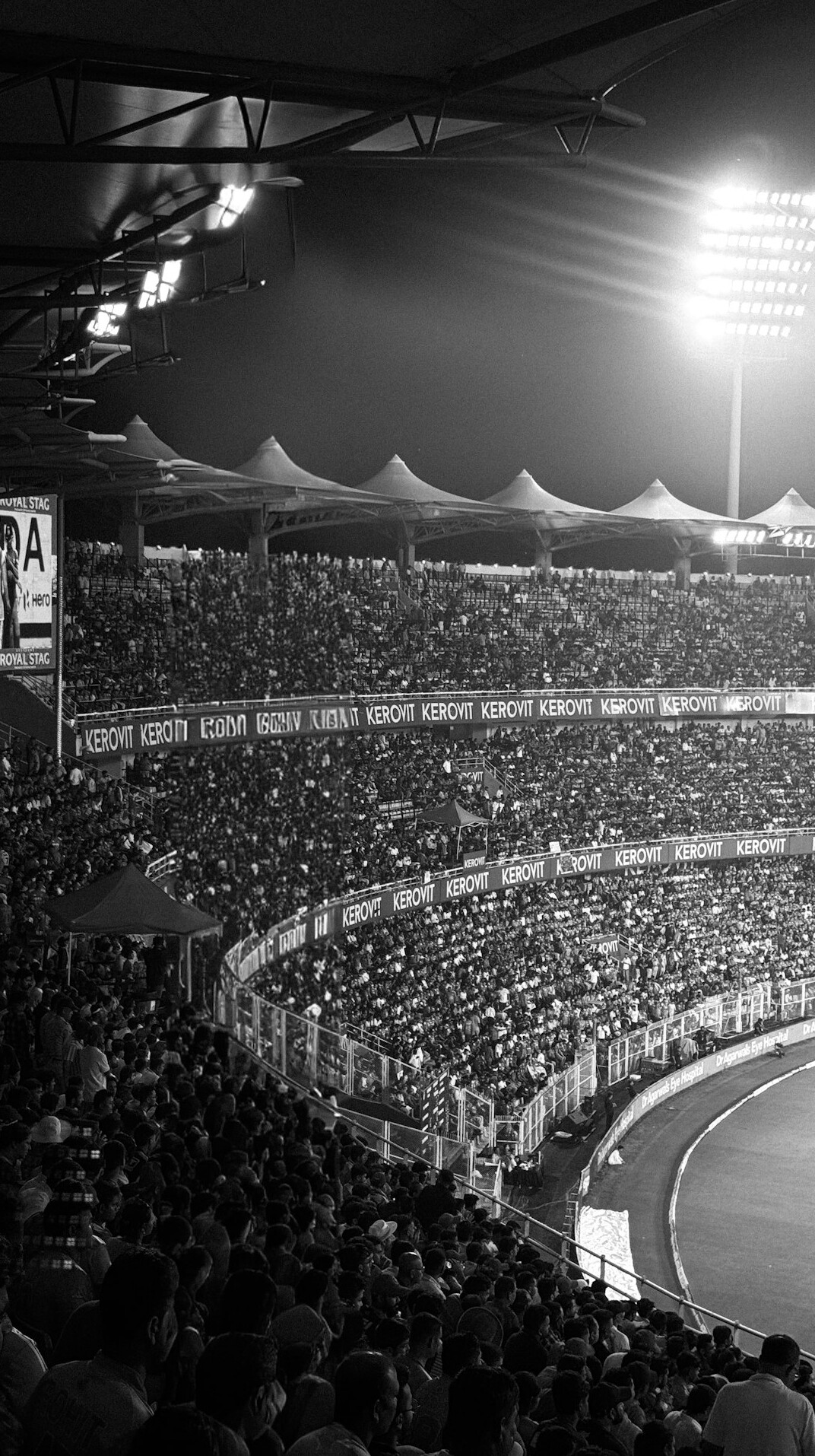 Football match in a packed stadium at dusk
