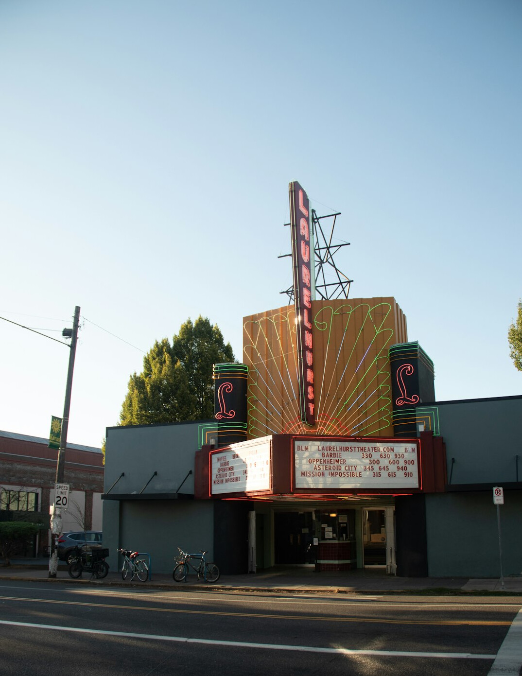 Cinema auditorium with red seats facing a large screen