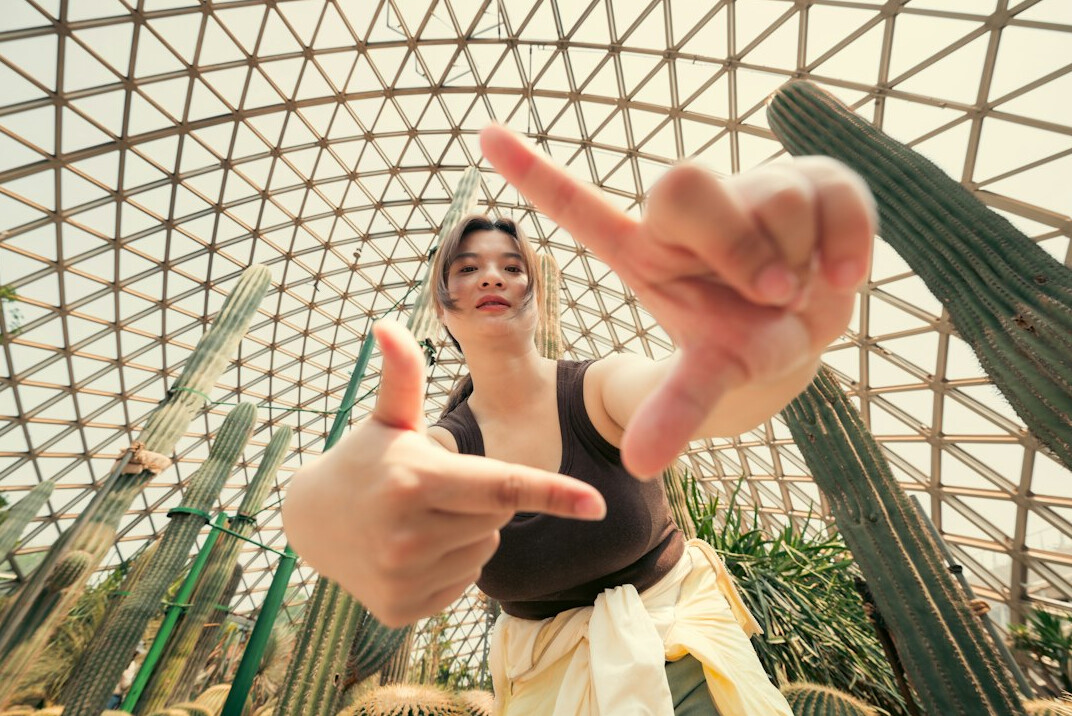 Portrait of a young woman with glasses in a greenhouse