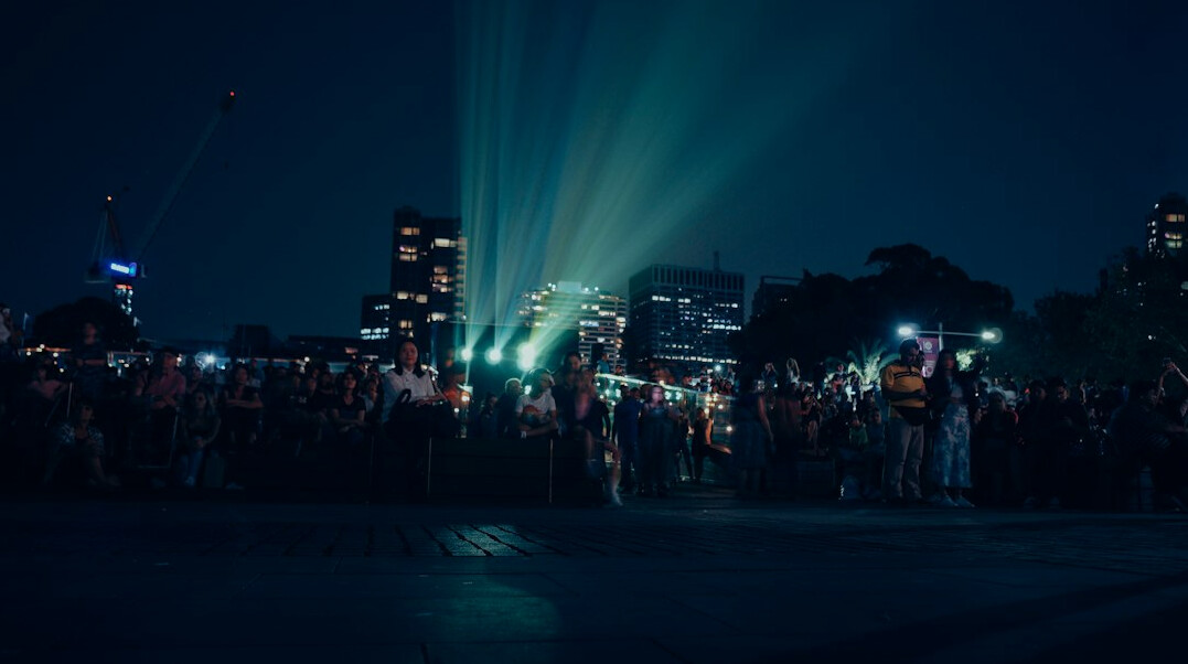 Festival crowd under bright stage lights at night