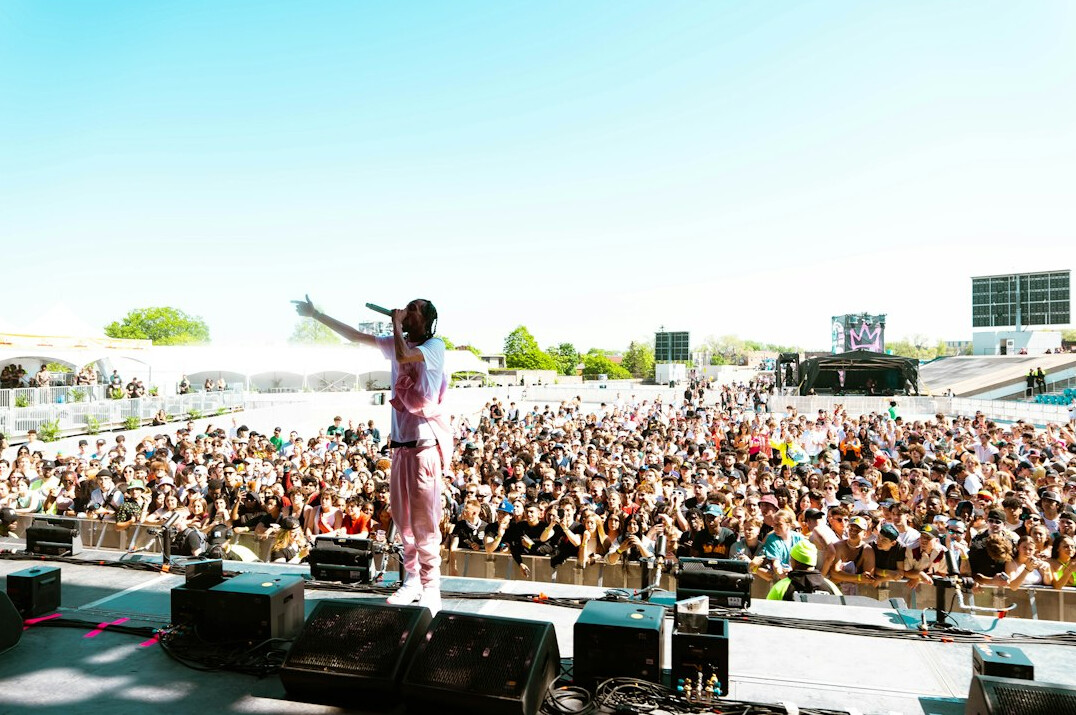 Singer performing on stage in front of a large crowd