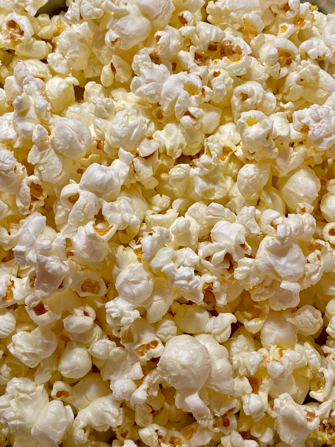 Popcorn and film reel on a dark cinema background
